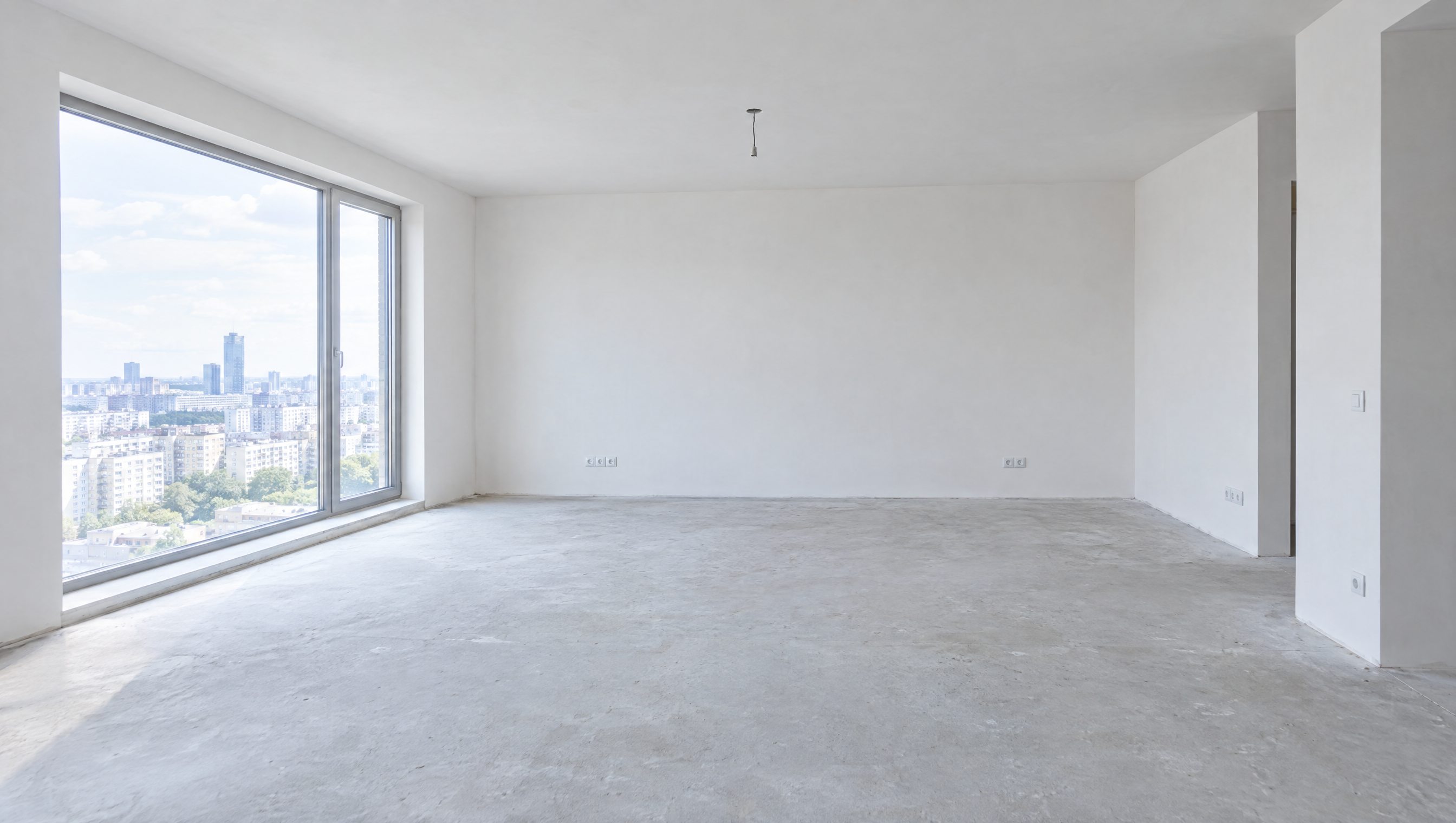 Empty white carcass apartment, bare plaster and concrete, no furniture
